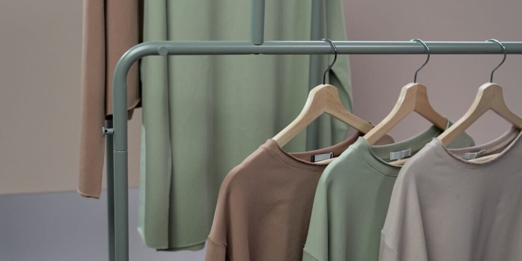 Minimalist clothing rack with knitwear in neutral tones