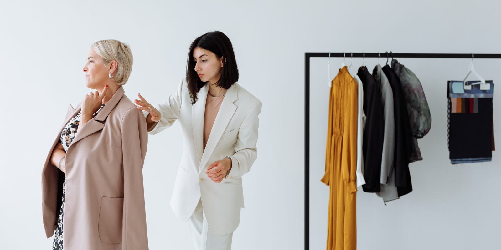 Minimalist clothing rack with knitwear in neutral tones