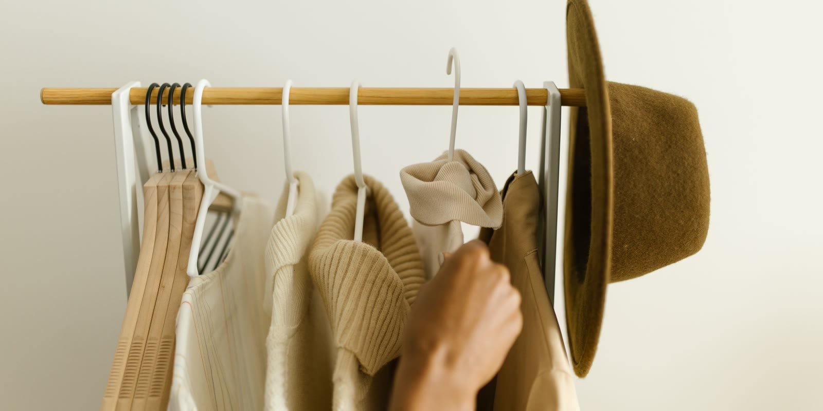 Neutral beige and brown clothes on a minimalist rack
