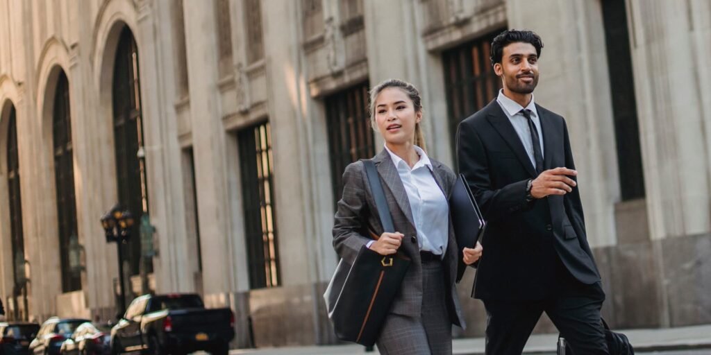 Businesswoman and businessman walking on a European street