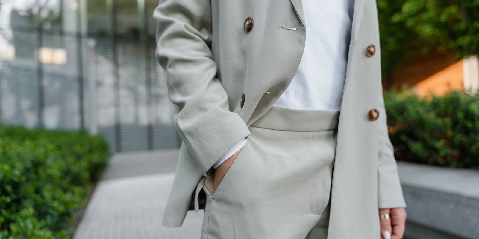 Light grey tailored suit with hand in pocket