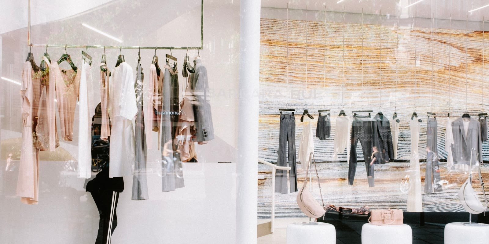 Elegant boutique with clothes on white racks