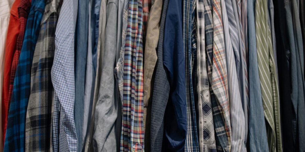 Crowded clothes rack full of shirts and jackets