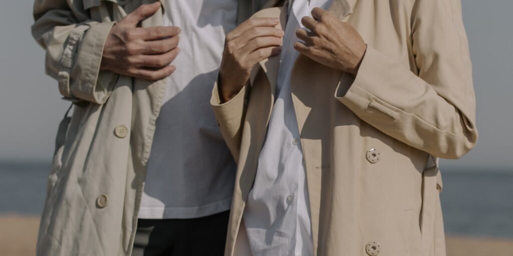 Two people in beige trench coats