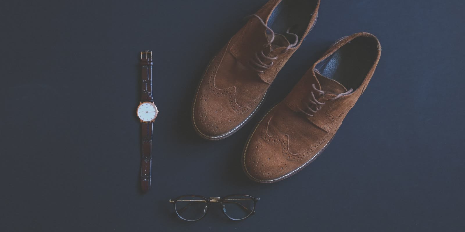 Brown leather brogues, wristwatch and glasses